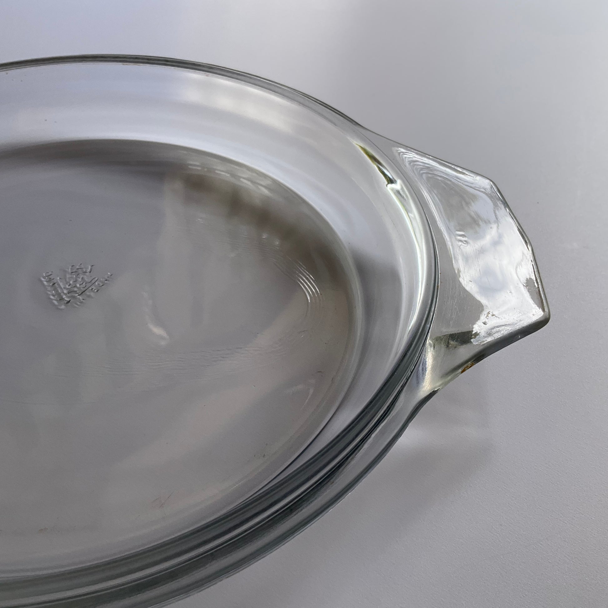 Pyrex JAJ clear tempered glass oven casserole lid with JAJ logo  on a white background 