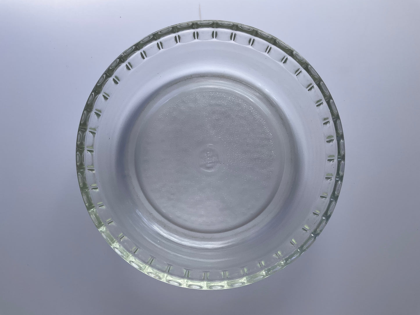 Above view of Pyrex clear tempered glass souffle dish on a white background