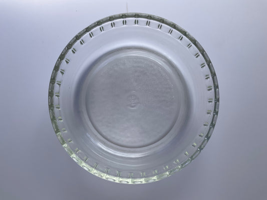 Above view of Pyrex clear tempered glass souffle dish on a white background