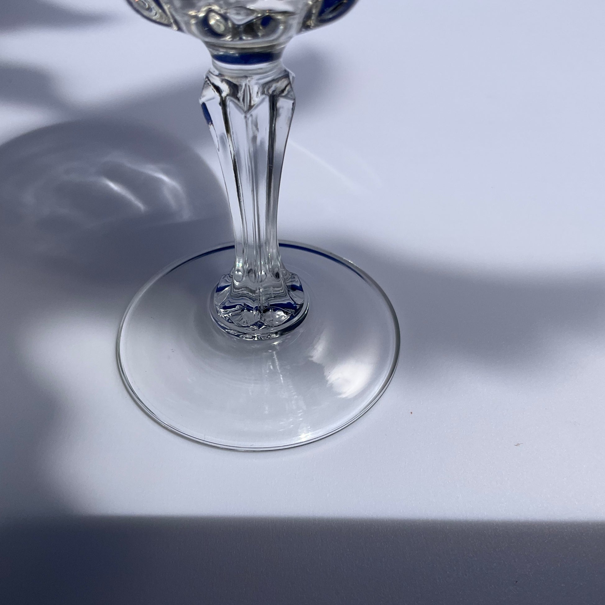 Close up view of the stem of a Luminarc stemmed swirly tempered vine glass on a white background