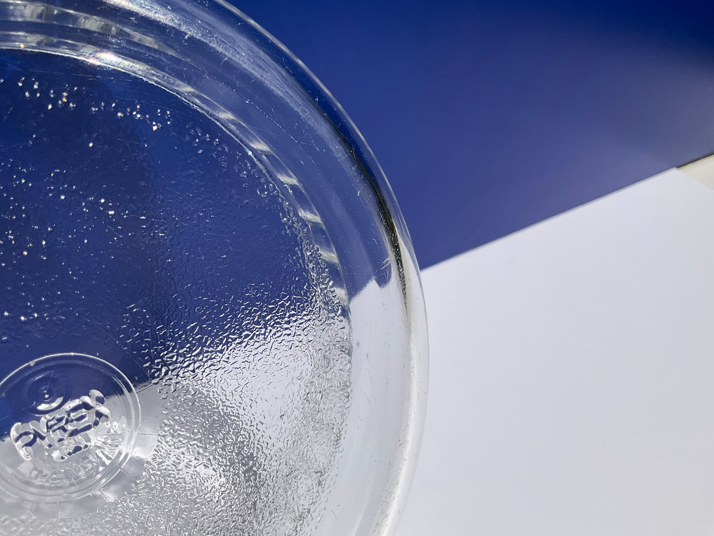 Close up view of Pyrex clear tempered glass ovenware souffle dish  with on a blue and white background